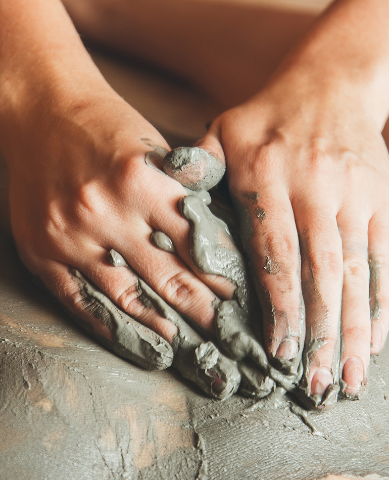 Person reviving a massage using mud treatment