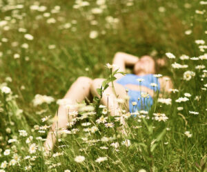 Woman laying down in a flower field
