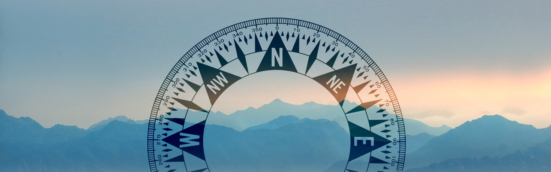 Compass on top of a mountain landscape