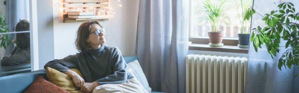 Woman sitting in a room with plants