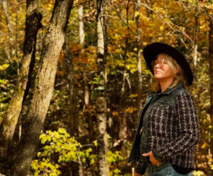Woman standing in a fall colored forest