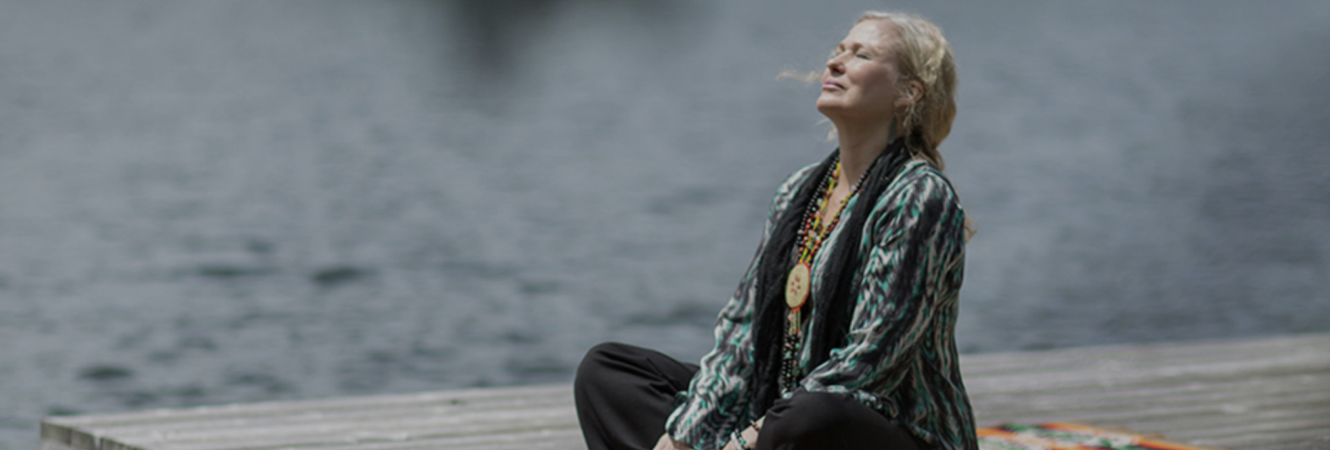 Woman meditating on a dock