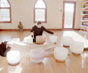 Woman using crystal singing bowls