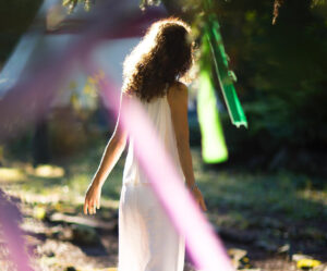 Woman standing among spiritual ribbons