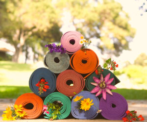 Stack of yoga mats adorned with flowers